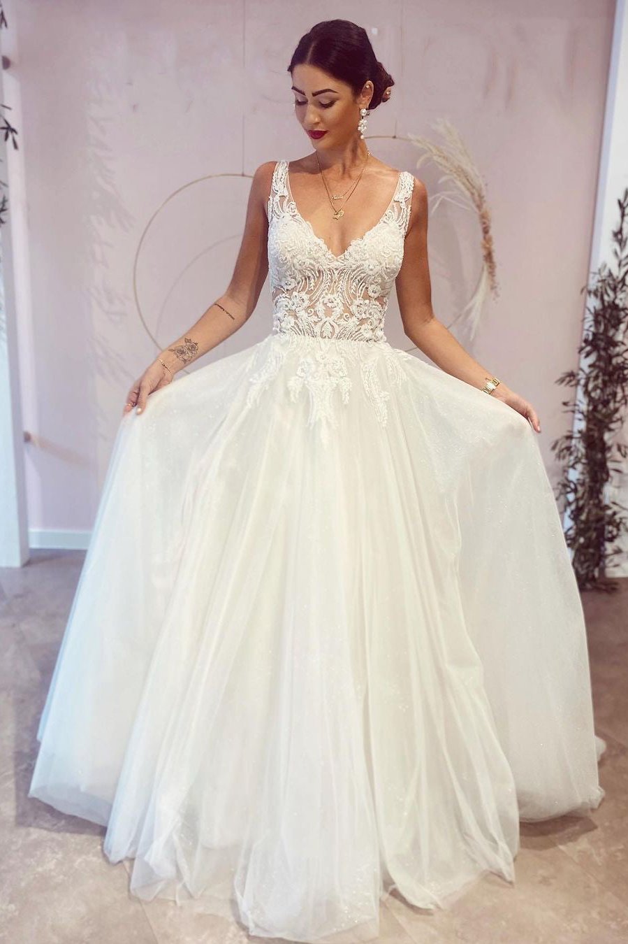 Elegantes, rückenfreies Brautkleid in A-Linie mit tiefem V-Ausschnitt und Spitzenapplikationen