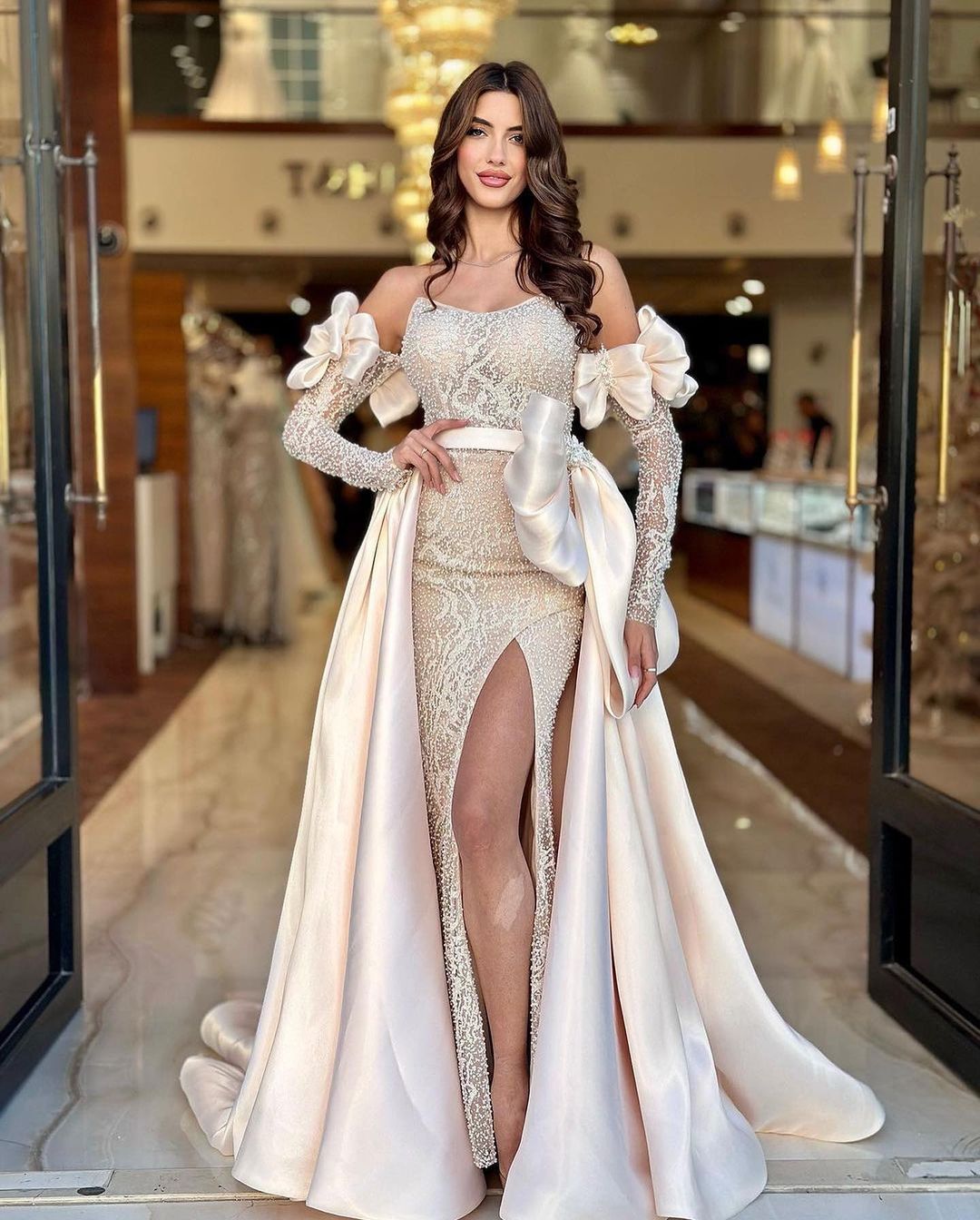 Champagnerfarbenes Hochzeitskleid mit Fliege und hohem Schlitz und Perlen