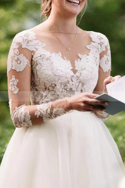 Transparentes bodenlanges Brautkleid aus Spitze mit langen Ärmeln und A-Linie aus Tüll